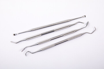 Set of dental instruments on a white background. Steel