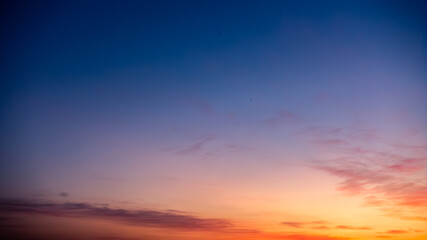Captured in transition, the photo showcases the sunset's gradient, transitioning from warm orange...