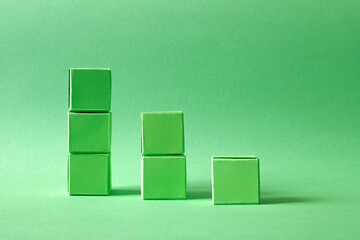 Ascending Stack of Green Cubes on a Soft Teal Background - Geometric Art