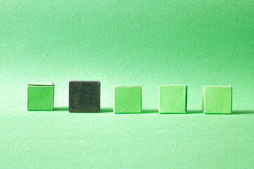 Arranged Green Cubes Casting Shadows on Green Teal Surface - Abstract Design Representing Eco-Friendly Development