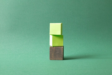 Arranged Green Cubes Casting Shadows on Green Teal Surface - Abstract Design Representing Eco-Friendly Development