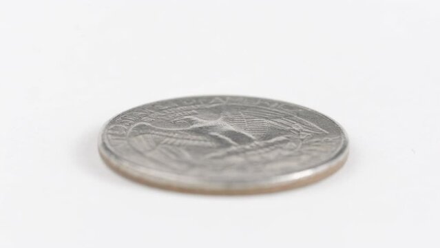 Silver Dollar Coin With Eagle Engraved On White Table. Isolated Object, Spinning