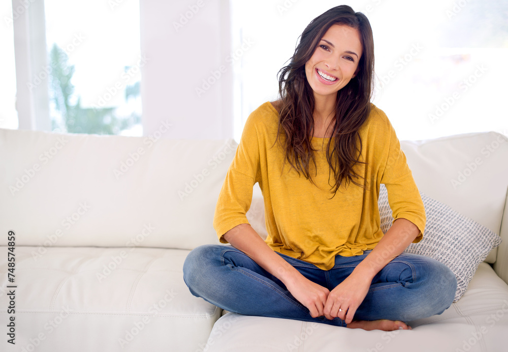 Poster Woman, happy and sitting in portrait on sofa to relax in home with pride, holiday and confidence in living room. Person, smile and break on vacation in lounge with couch at apartment in Barcelona