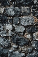 A monochrome image of a textured stone wall. Perfect for design projects.