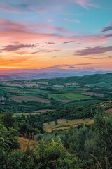 Fototapeta na wymiar A peaceful sunset view of the countryside from a hilltop. Ideal for nature and landscape themes