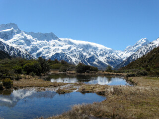 Southern Alps and Aoraki Mt Cook reflecting in the pristine Sealy Tarns on a beautiful day on New Zealand's South Island