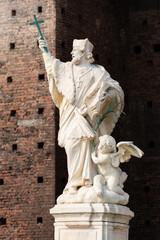 John of Nepomuk statue of a priest holding a cross with an angel at Milan Italy