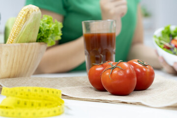Low calories drink for wellness. woman making homemade drink by extracting fresh tomato juice.