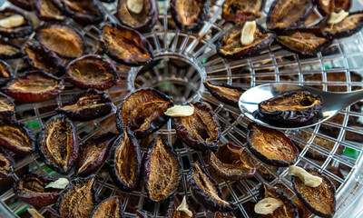 Plums dried in a dehydrator. Selective focus.