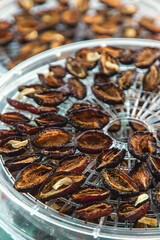 Plums dried in a dehydrator. Selective focus.