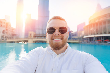 UAE business tourism for cryptocurrency concept. Happy young crypto businessman man tourist in...