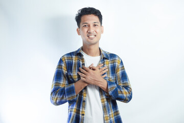 Adult Asian man wearing flannel shirt showing relieved gesture