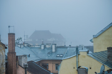 Fototapeta na wymiar Old town in the fog. Roofs of houses on a foggy morning in Lviv. Old houses in the fog. Ukraine.