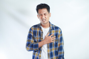 Adult Asian man touching his chest with pain expression