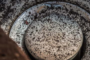 Falling dirty particles from a water filter in a white washbasin. Elements of a filtration system...