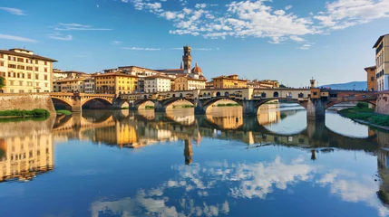 Photo sur Plexiglas Ponte Vecchio A bridge over the calm Arno river in Florence Italy
