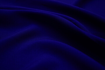 Texture of dark blue fabric closeup. Low key photo. Plexus threads. Clothing industry. Abstract background. Textile waves.