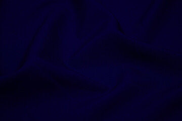 Texture of dark blue fabric closeup. Low key photo. Plexus threads. Clothing industry. Abstract...