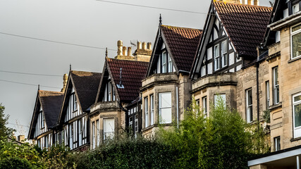 Fototapeta na wymiar The photo presents homes with gabled roofs, a hallmark of traditional English architecture, encapsulating the quaint charm and timeless allure of residential neighborhoods
