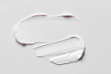 White cosmetic cream smudge swatch pattern