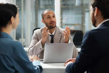 Lawyer working with clients at table in office