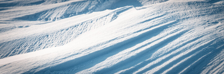 Snow texture. Wind sculpted patterns on snow surface. Wind in the tundra and in the mountains on...