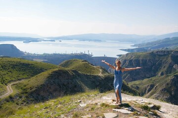 Obraz premium Spectacular Mountain and Lake View with a Young Woman in a Graceful Blue Dress