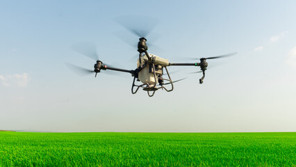 Agriculture drone fly to sprayed fertilizer on the  fields. smart farmer use drone for various fields like research analysis, terrain scanning technology, smart technology concept.