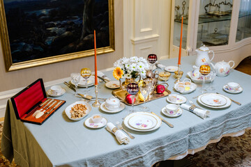 An old forfor service. A set table for 4 people for dinner. Forfor with hand-painted and 24 carat gold. Vintage Classic Rarity France