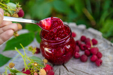 Raspberry jam in the garden. Selective focus.