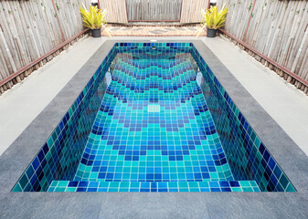 Empty small blue private swimming pool