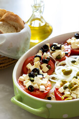 Greek Cheese and Tomato Salad with Olives, Onion, and Olive Oil - Fresh and Flavorful Mediterranean Dish.