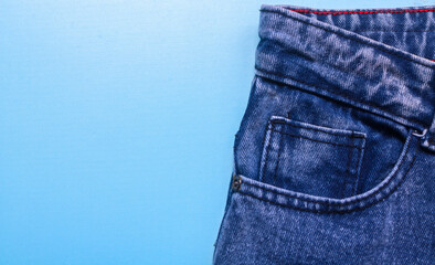 Front pocket of blue denim jeans with prominent stitching. Close up of jeans with lots of pockets