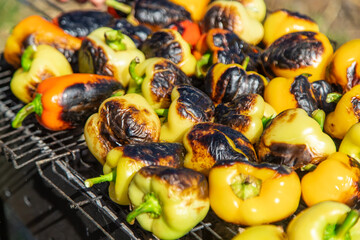 Man grilling sweet peppers. Selective focus.