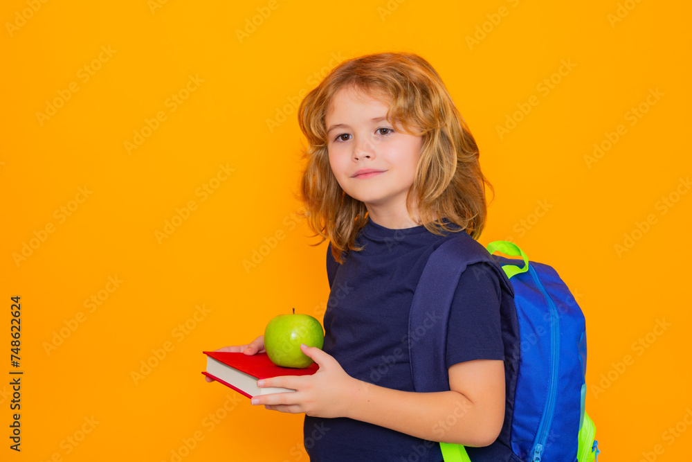 Poster back to school. school child from elementary school with book and apple isolated on yellow backgroun