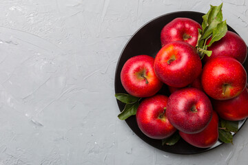 Many red apples on cement background, top view. Autumn pattern with fresh apple above view