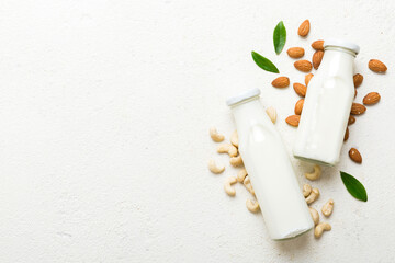 Set or collection of various vegan milk almond, cashew, on table background. Vegan plant based milk and ingredients, top view