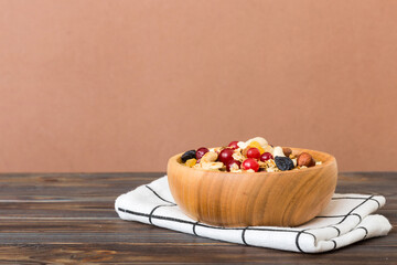 Cooking a wholesome breakfast. Granola with Various dried fruits and nuts in a bowl. The concept of a healthy dessert. Flat lay, top view with copy space