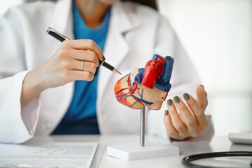 Female doctor provides crucial guidance to a male patient in a clinic room, discussing heart attack...