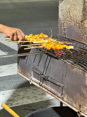 Grilled squid on a charcoal grill. Thai street food