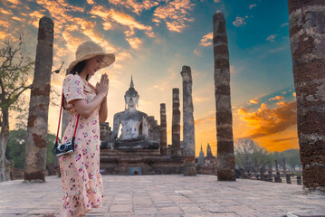 Sukhothai, Thailand Traveler and woman tourist enjoy walking to see the historic park of Thailand.