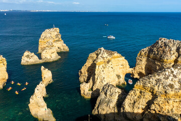 Ponta da Piedade, panoramic view of famous rock formations with arches at sunset, Lagos, Algarve, Portugal.