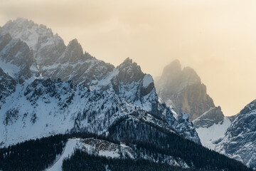 Peaks of Italian Dolomites in misty winter day. - obrazy, fototapety, plakaty