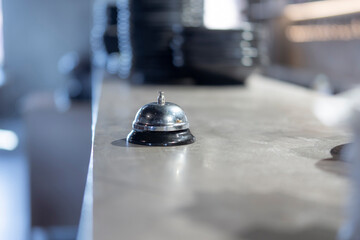 Service Bell on the Counter at a Bustling Restaurant During Peak Hours