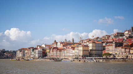 Porto, Portugal old town ribeira promenade view with colorful houses, Douro river and boats