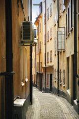 Travel, architecture and alley in vintage city with history, culture or holiday destination in Sweden. Vacation, old buildings and antique stone street in Stockholm with cobble path in ancient town
