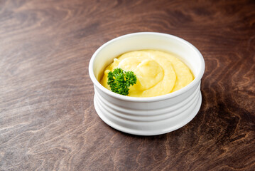 Fresh creamy mashed potato in white bowl on table