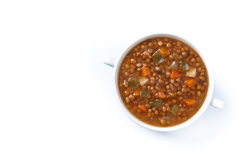 Lentil soup with vegetables in bowl isolated on white background. Top view. Copy space