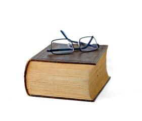 Old, book and glasses with ancient manuscript for knowledge, literature or history on a white studio background. Closeup of historic novel or spectacles for vintage scripture or reading on mockup