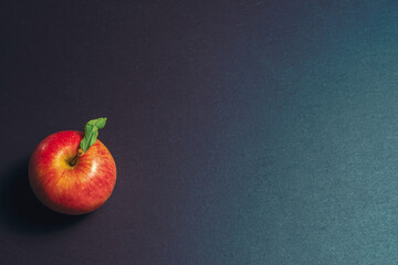 one apple on a stone kitchen table close up